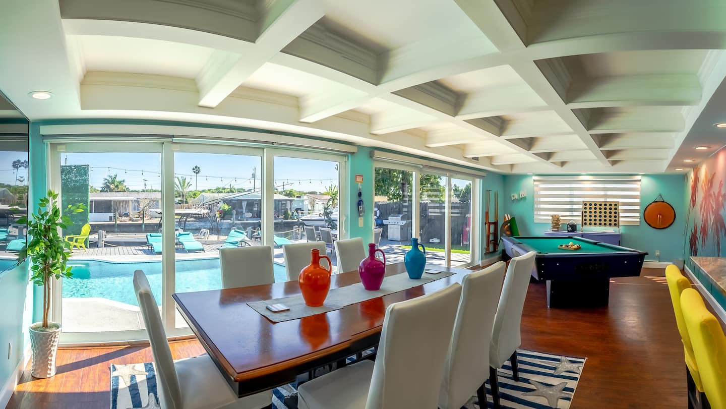 Open dining and game room overlooking the pool and canal